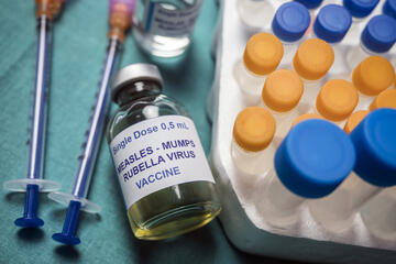 Different vials of triple viral vaccine of measles, rubella and mumps, known as MMR, conceptual image